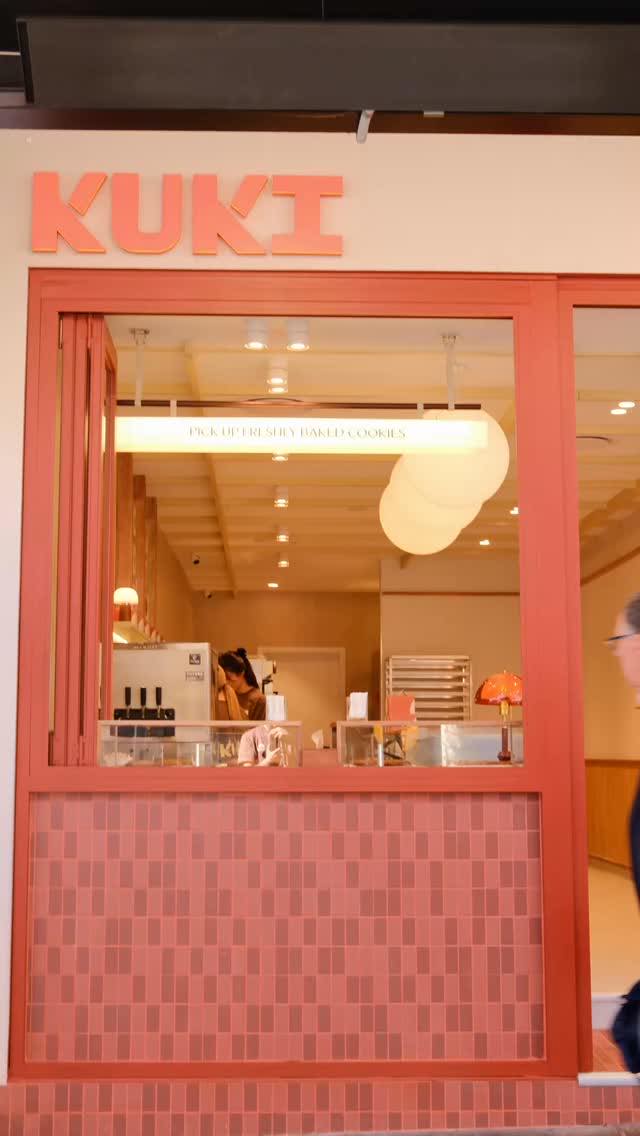 The KUKI Burwood shopfront: coral window frames, KUKI letters above the window and a checker-tiled counter base.